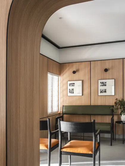 An arched doorway frames the view into a secondary waiting area. This architectural element is repeated to create a sense of rhythm and flow throughout the clinic's interior.