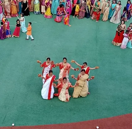 The performers strike a final pose, concluding their elegant dance at the Dandiya event.