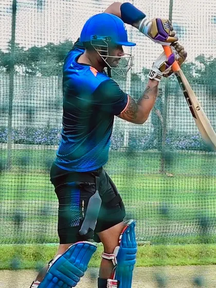 An action shot of a professional batsman during a practice session, displaying the focus and form of an elite athlete.