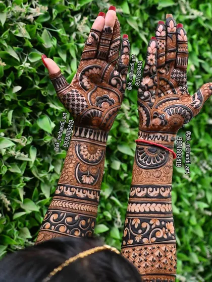 The back of the hands from the same bridal session, showing how the design continues with a beautiful outdoor background.