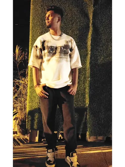 A stylish outdoor shot at night. My personal style is an extension of the cool, urban energy I bring to my music.