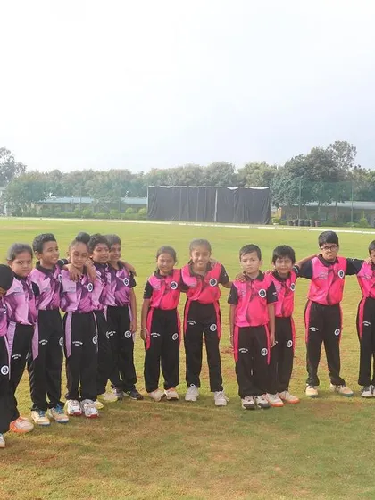 A U-10 team huddles together on the field, building team spirit before their game.