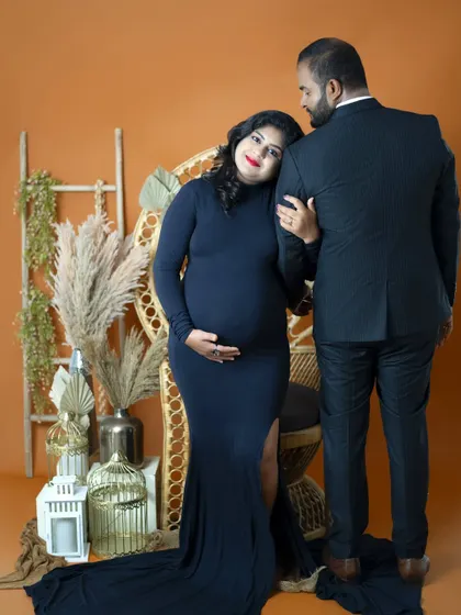 A moment of quiet reflection and support. The mom-to-be rests her head on her partner's shoulder, a simple gesture that speaks volumes about their bond.