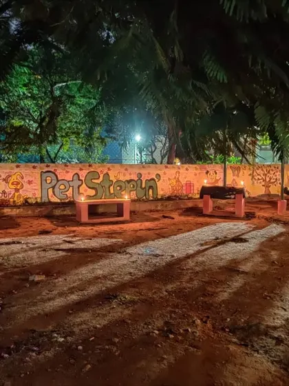 Our main play area by night, with the PetStepin mural and benches lit by traditional diyas for a peaceful Diwali.