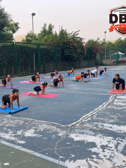 A group of young athletes in a kneeling yoga pose. We guide them through each movement to ensure correct form and prevent injury.