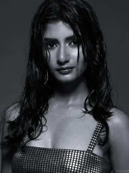 An intense black and white close-up, focusing on the model's expression.