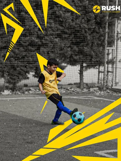 A young player focuses on his shot during practice.