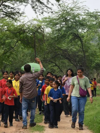 Our team leads a group of students from various charity schools on a walk through Aravali Nagar Van before their plantation drive.
