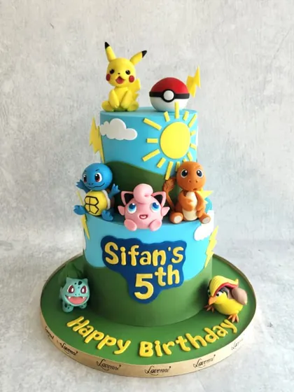 A Pokémon party for Sifan's 5th birthday! This two-tiered cake is covered in all his favourite characters, including Pikachu, Squirtle, Charmander, and Bulbasaur.