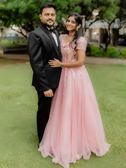 The perfect outfits for the perfect "Yes!". This couple looks stunning in a coordinated pink gown and classic tuxedo for their engagement announcement.