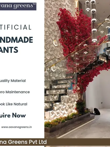 A magnificent handmade red flowering tree installed next to a modern staircase. This is a perfect example of how our custom trees can be designed to fit a specific space and create a powerful visual statement.