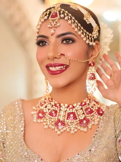A complete bridal look featuring one of my classic red Meenakari and Kundan necklace sets. This rental set includes a choker, matching matha patti, nath, and earrings, designed for the traditional bride.
