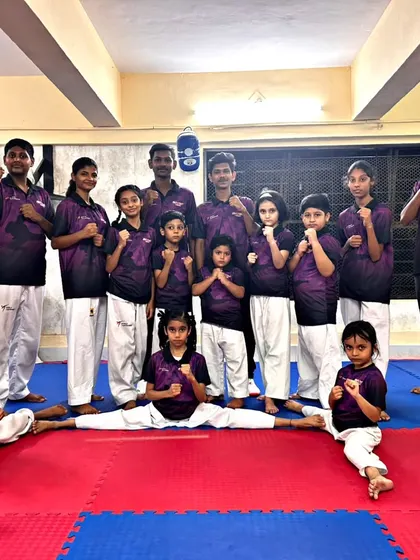The whole team is ready to fight. Students of all ages and sizes pose together, showcasing the inclusive and supportive community we've built.