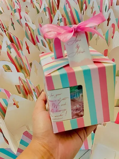 Preparing a large order of our striped baby shower favor boxes.