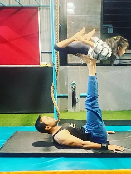 Another partner stunt, with me as the base supporting a young gymnast. These exercises are a fun way to build serious strength and balance.
