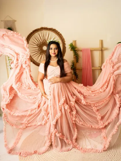 A dynamic shot of the peach gown with the fabric tossed to create beautiful, flowing wings. This adds a "wow" factor to the portrait.