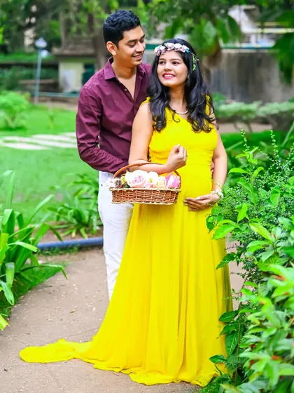 The bright yellow gown brings a feeling of sunshine and happiness to this outdoor maternity portrait. The couple's pose is natural and full of affection.