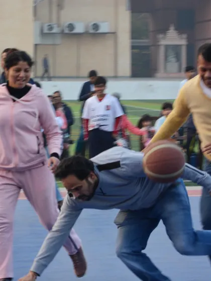 A moment of hustle during the parents' game. It's all in good fun, but the competitive spirit definitely comes out.