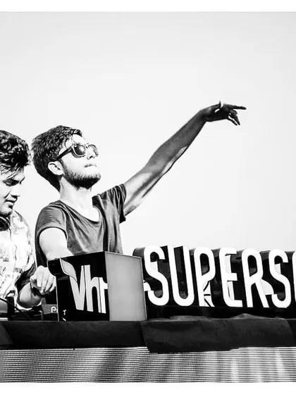 A throwback to our set at Vh1 Supersonic. This black and white photo captures the classic DJ pose, pointing to the sky and feeling the music.