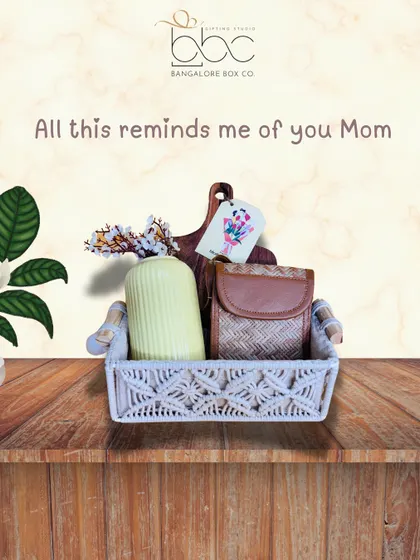 A simple yet elegant Mother's Day basket featuring a ceramic vase and a chic purse. Sometimes, the most beautiful gifts are the ones that remind you of her style.