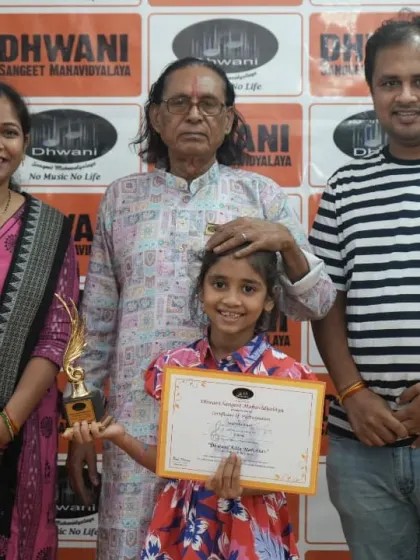 A student with her family and guru, celebrating her win.