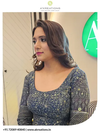 A side profile of this chic evening look, highlighting the soft contours of the face and the beautifully shaped hairstyle.