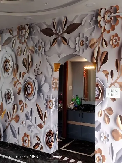 An intricate 3D floral wallpaper that covers the entire wall and wraps around a doorway. The metallic and white flowers create a luxurious, textured effect.