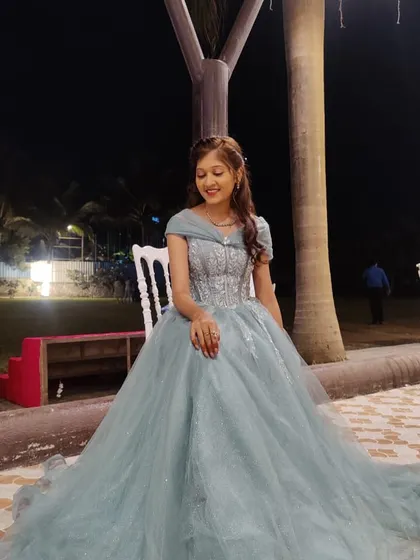 A quiet moment of reflection. This off-shoulder dusty blue ball gown offers a soft, romantic, and elegant look, perfect for an evening event or pre-wedding shoot.