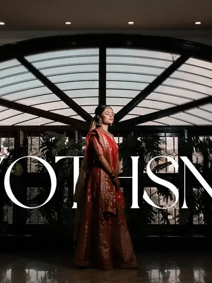 A dramatic and cinematic bridal portrait, with the bride's name elegantly overlaid, showcasing her in a beautifully lit hall.