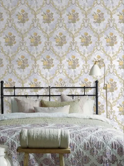 A bedroom mockup with a traditional gold and grey floral damask wallpaper behind a metal-frame bed.