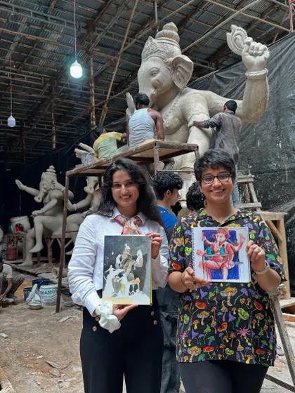 Me and a fellow artist proudly showing our work at the Ganpati idol workshop. The background shows the raw, beautiful chaos of the workspace, where these magnificent idols are born.