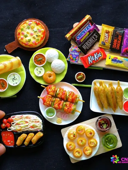 A collection of miniatures including paneer tikka, dosa, idli, pizza, and chocolates.