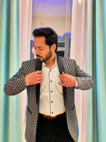 Adjusting my jacket, a classic pose that exudes confidence and style before hitting the stage.