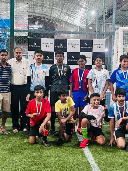 The older category winners from the in-house football tournament, proudly displaying their medals.