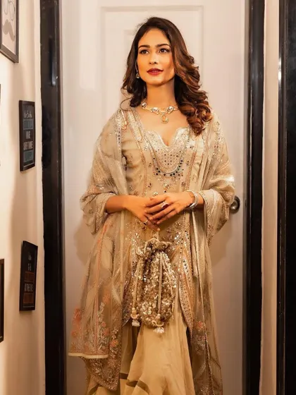 A candid-style shot of Aneri Vajani. The soft waves and glowing makeup look beautiful from every angle, perfect for wedding photography.