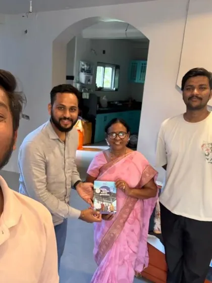 Our team with a family, holding our "Built for Generations" booklet. We are committed to quality and long-term service.
