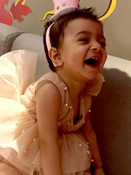 Pure joy. This little one is having a wonderful time in her beige tulle party dress, which is detailed with delicate pearls scattered across the fabric for a touch of sparkle.