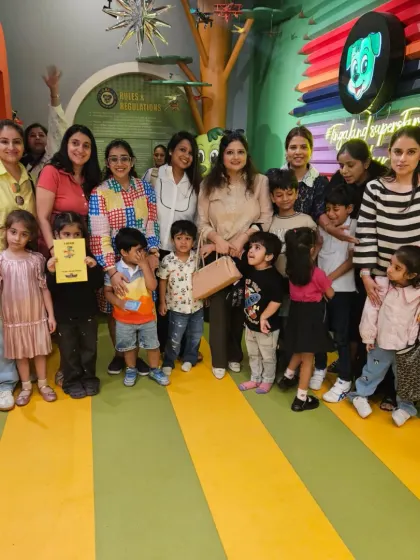 A large group of kids and adults gather for a photo. Our venue is spacious enough to comfortably accommodate families and friends for a big celebration.