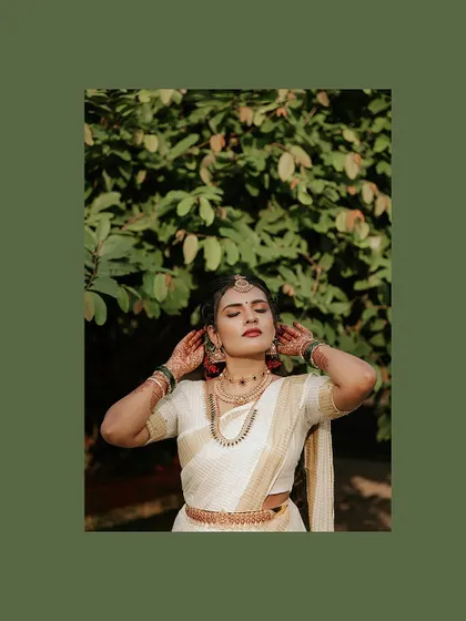 A serene and sun-kissed portrait of the bride, her eyes closed in a moment of peace.