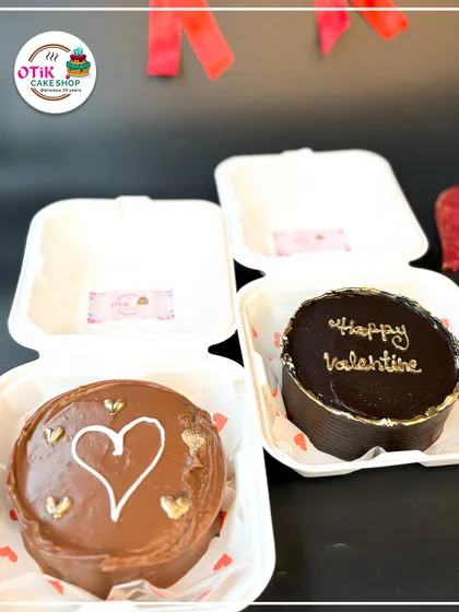 Two of our chocolate bento cakes, perfect for Valentine's Day. One features a simple heart, while the other has an elegant "Happy Valentine" script in gold.