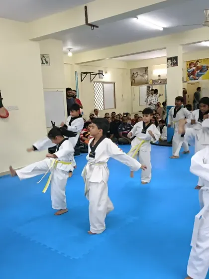A class of white and yellow belts practicing their front kicks.