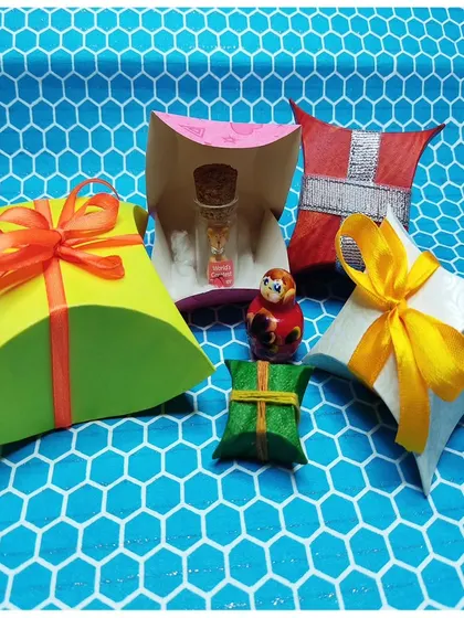 A playful assortment of handmade gift boxes in different shapes and sizes. Perfect for adding a special touch to small gifts and party favors.