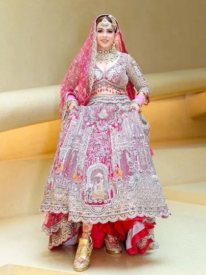The bride showing off her full lehenga and her cool wedding sneakers.