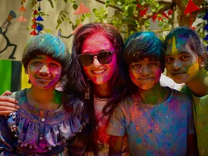 Posing with a group of kids, all smiling and covered in gulal. I am experienced in engaging children and making the event fun for them too.