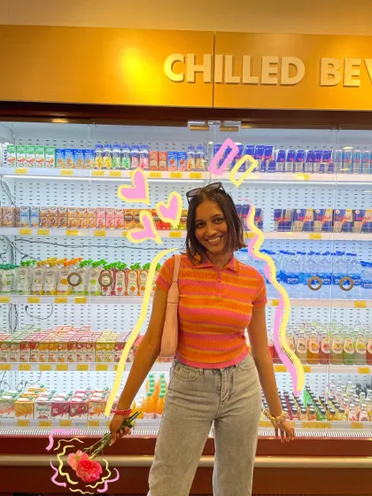 A happy photo in the grocery store, with a neon-style outline and hearts.