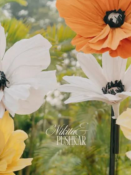A creative shot focusing on the large, artistic paper flowers that formed part of the Haldi decor.