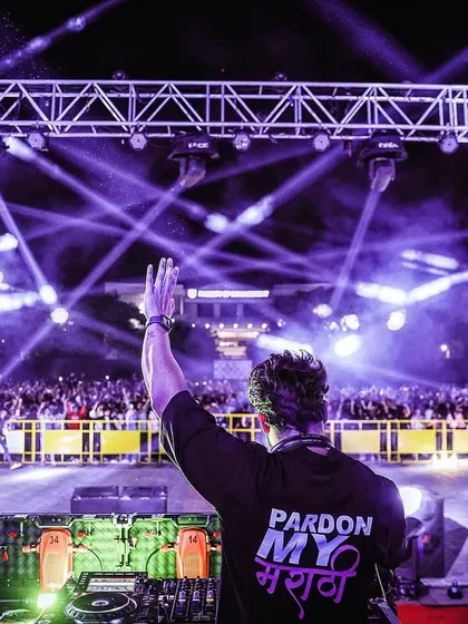 Waving to the massive crowd at a campus festival. The 'Pardon My मराठी' on my shirt is a proud nod to my roots, no matter how big the stage is.