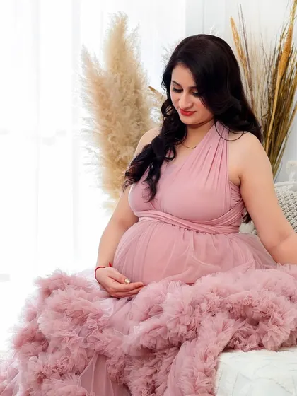 A variety of poses in a beautiful ruffled pink gown, showing its versatility for creating soft, romantic, and glamorous solo maternity portraits.