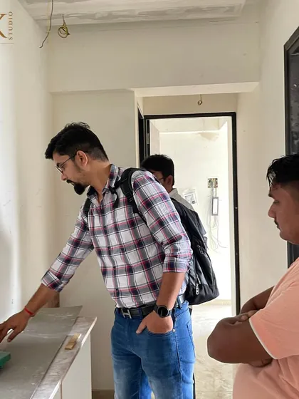 On-site with my contractor, pointing out the exact locations for electrical points and fixtures. These small details are critical for a functional design.