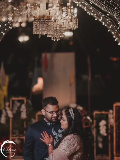 A romantic portrait of the couple, framed by the light-strung archway of the entrance tunnel. This shows how decor can also serve as a beautiful, intimate photo opportunity.